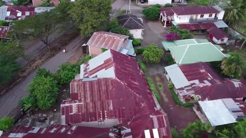 Aerial drone shot of suburb area surrounded by green eco-friendly environment.