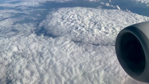 Thick Carpet Of Fluffy Stratus Clouds Seen From Window Airplane On Flight. Wide