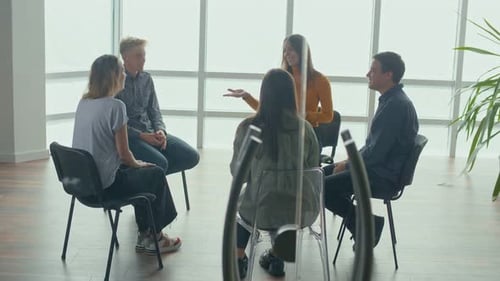 People Sitting in a Circle During a Group Therapy Session Communicate