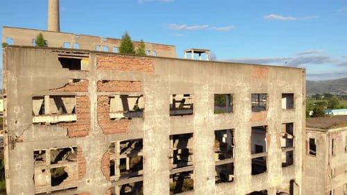Ruined buildings of old coal power plant built on city suburb of Korca in Albania during communist r