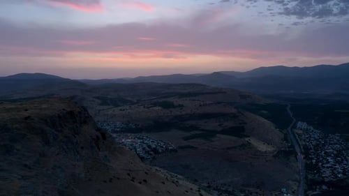 Small town in the desert with mountains at sunset aerial view