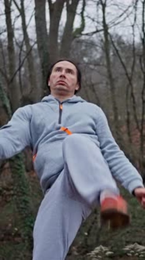 Adult Male in Grey Sweat Suit High Kick