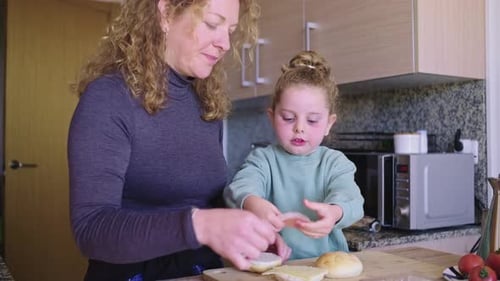 Mother and Child Prepare Sandwiches in Kitchen