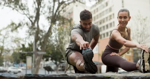 Man and Woman Stretching Legs in City Park