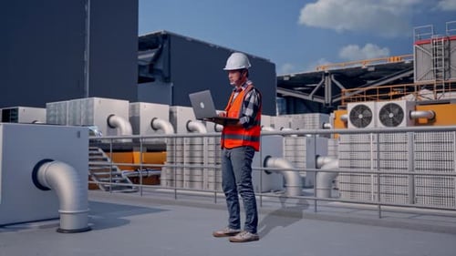 Full Body Side View Of Asian Male Engineer Working On A Laptop On Rooftop HVAC