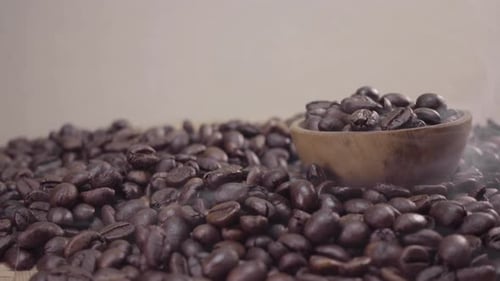 Roasted coffee beans on a small wooden bowl