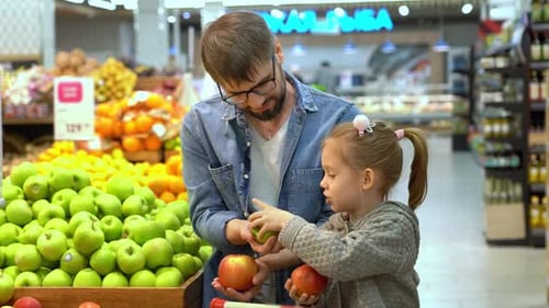 Happy Family Choose Apples in Supermarket Shopping Food in Store