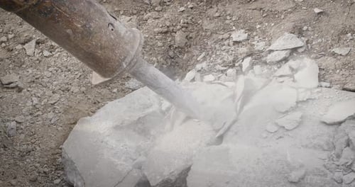 Jackhammer breaking up sidewalk rocks