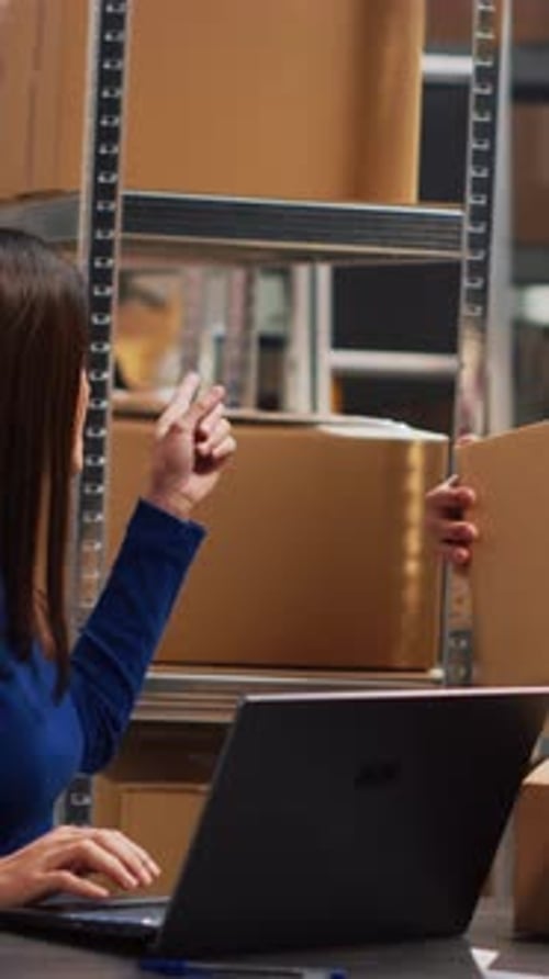 Vertical Video Young Adult Analyzing Packs of Goods in Warehouse