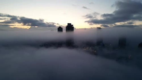 Cityscape Obscured in the Fog During Sunrise