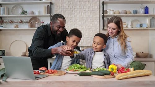 Family Prepares Healthy Salad Together in Kitchen