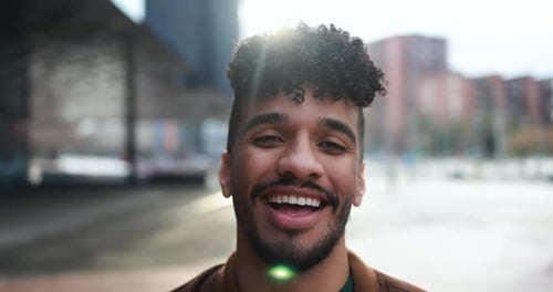 Smiling young man looks toward the camera