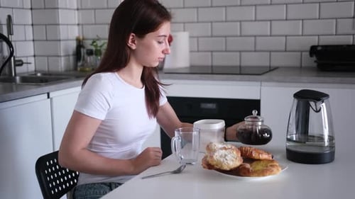 Girl Pours Tea At Table