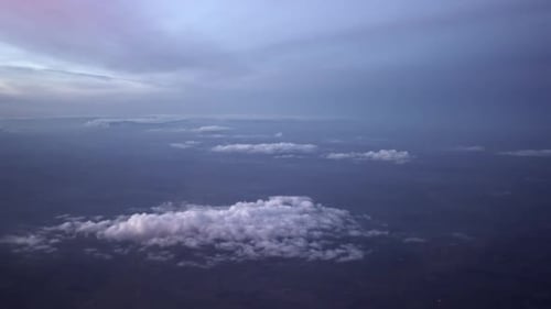 Plane Footage Of a Sea of Dense Fluffy White Clouds with Day Sky From an Airplane