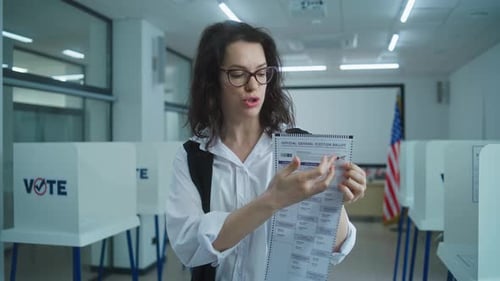 Woman Explains Election Ballot in Polling Place