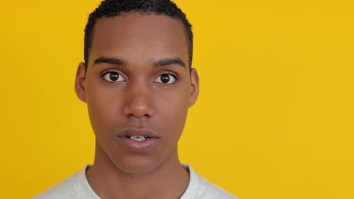 Surprised Young Man Looking at Camera