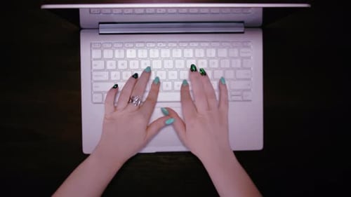 Woman Typing on Silver Laptop Overhead View