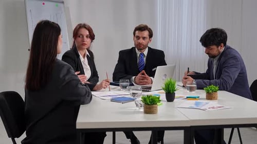 Business Meeting with Four People in Office Setting
