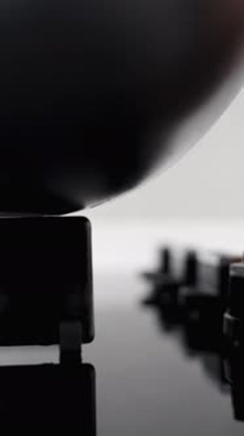 A close-up panoramic view shows the gas burner on the black stove being ignited with a large pot on