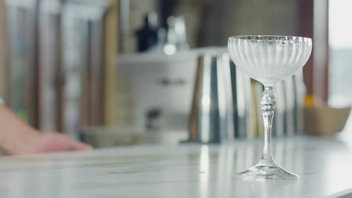 Cocktail being poured into a glass