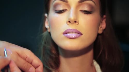 Woman Receives Lip Gloss from Make-Up Artist