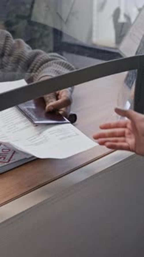 Passport and Documents Exchanged at a Service Window
