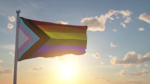 Waving Progress Pride Flag Against a Sunny Sky