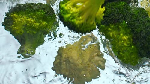 Pieces Broccoli Cauliflower Falling Clean Water in Super Close Up