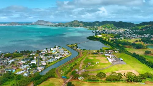 Beautiful golf course surrounded by residential area. Drone flight above the scenery of Honolulu