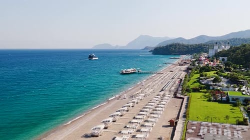 Aerial Video Beachfront Hotels in Turkey with Mountain Backdrop
