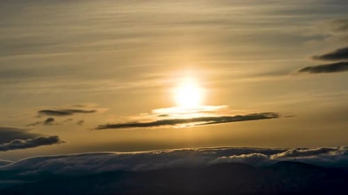 The golden sky and cloudscape provides a scenic view in the fast moving time lapse at sunset