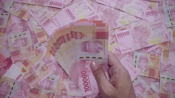 Pile of Indonesian Rupiah Banknotes with Hand Adding Stack, Business ...