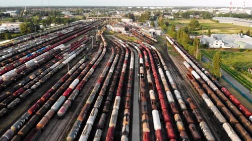 Aerial dolly shot Showing Large Train Depot With Many colorful cargo Trains