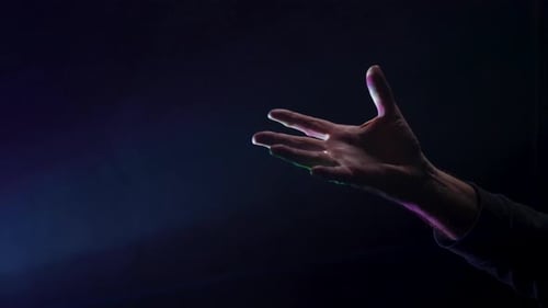 Dramatic Hand Gesturing in Studio with Colored Lights