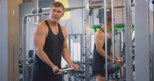 Gym Workout Bicep Exercise Middle Aged Caucasian Man Trains His Bicep Muscles in the Gym