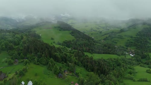 Aerial Hyperlapse of Vibrant Green Spring Rural Landscape in the Carpathians Mist and Low Clouds