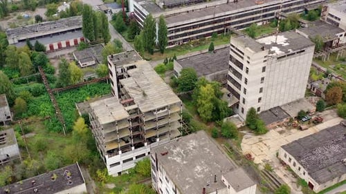 View from above of ruined and abandoned factory. Aerial view of industrial destroyed city buildings.