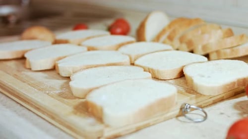 Bread Slices and Tomatoes on Wooden Cutting Board