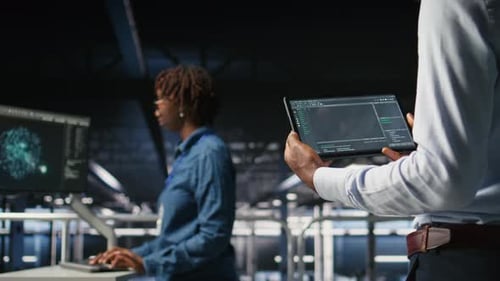 Close Up of Data Center Programmer Looking at Code Debugging Tools on Tablet