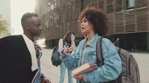 Students stand on campus discussing projects