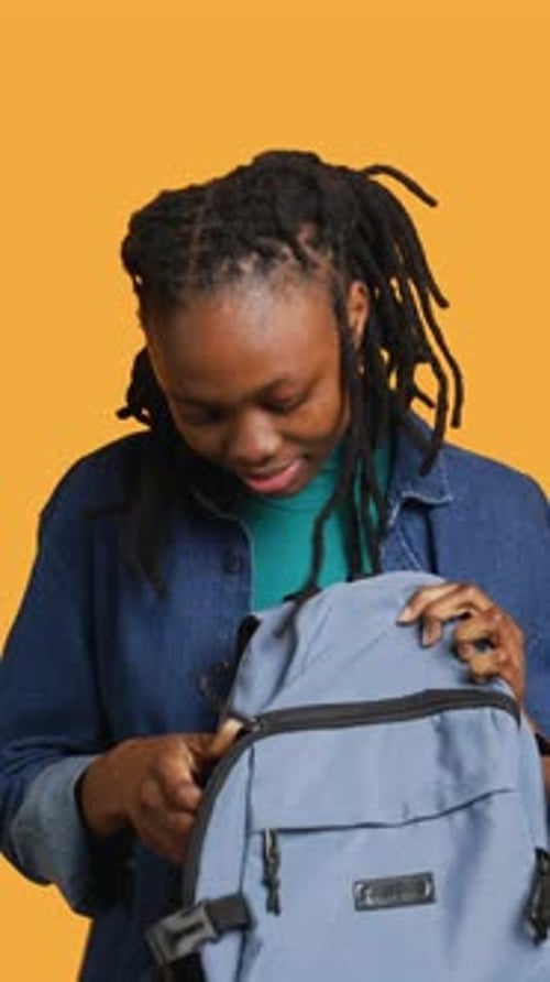 Vertical Video Girl Taking Out Business Class Materials Out of Rucksack Studio Background
