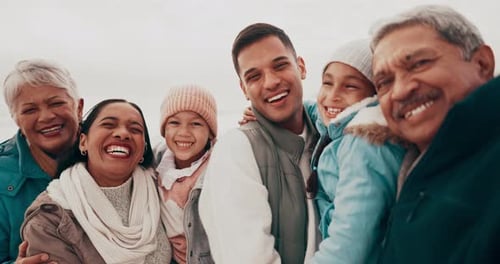 Happy Family Laughing Together on Beach Vacation