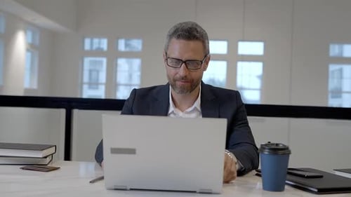 Middle Aged Businessman Working with Laptop in Office Hispanic Business Man Using Laptop Millennial