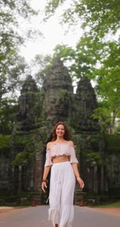 Beautiful Woman Approaching Camera In Slow Motion At Bayon Gate Cambodia