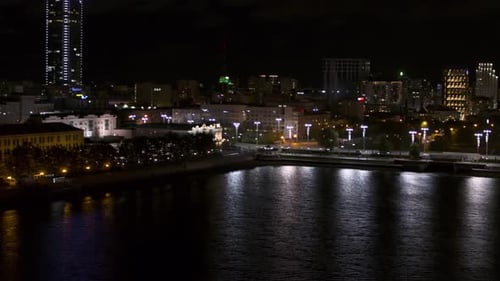 Night City Near the River Stock footageA Metropolis with Huge Officeslights and a Road Where Cars