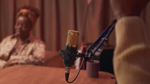 Podcaster Clapping Hands during Studio Discussion with Female Guest