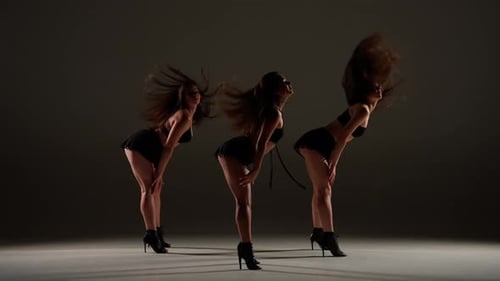 Group of Three Women Dancing Heels Dance in a Studio Plain Shadowed Background Spotlight Black Sexy