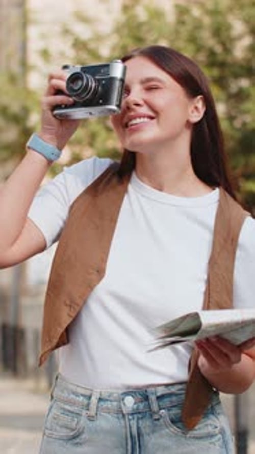 Woman Exploring City with Map and Vintage Camera