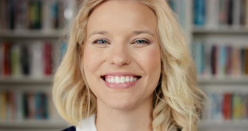 Woman, face smile or library books on school, university or college campus and education motivation