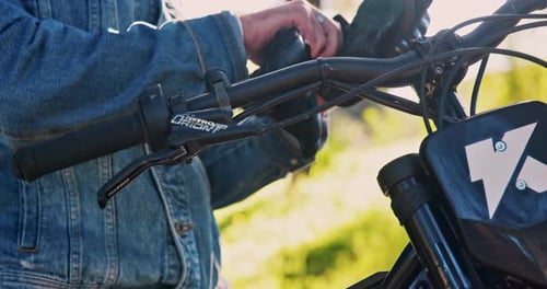 Hands, motorcycle and put on gloves closeup outdoor for safety, protection and travel equipment